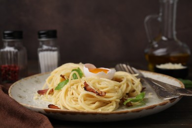 Photo of Delicious pasta Carbonara served on wooden table