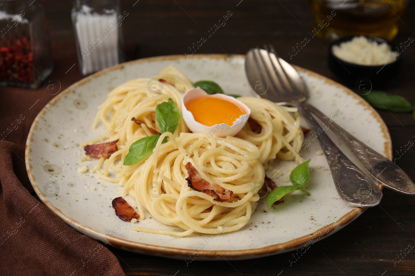 Photo of Delicious pasta Carbonara served on wooden table