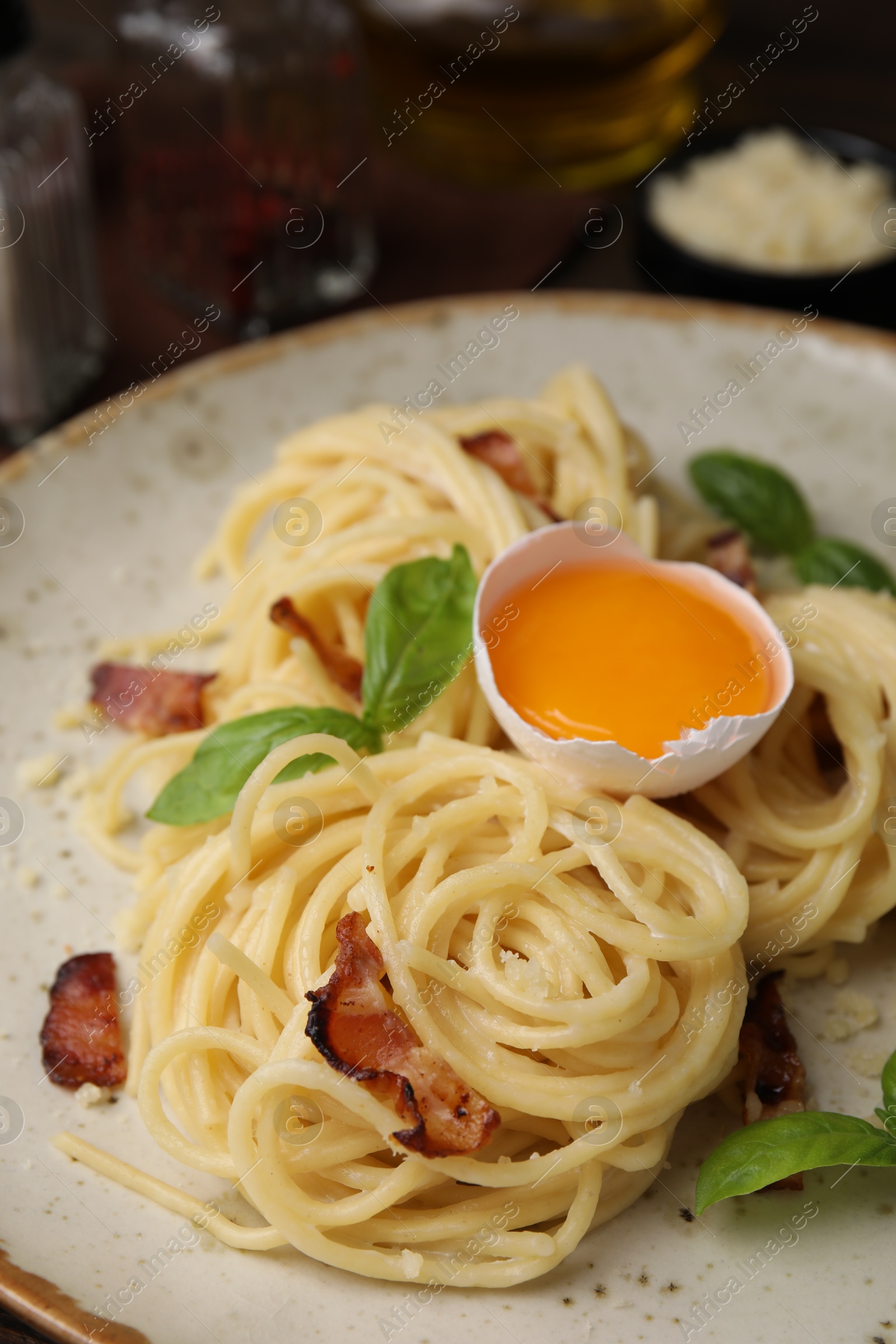 Photo of Delicious pasta Carbonara served on table, closeup