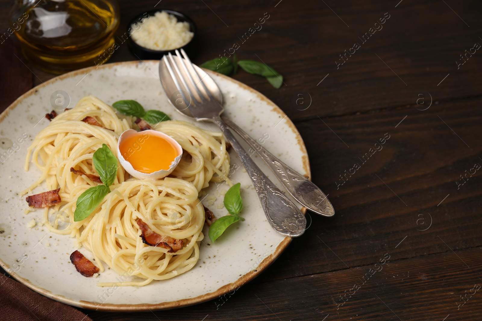 Photo of Delicious pasta Carbonara served on wooden table