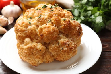 Delicious baked cauliflower with thyme on table, closeup