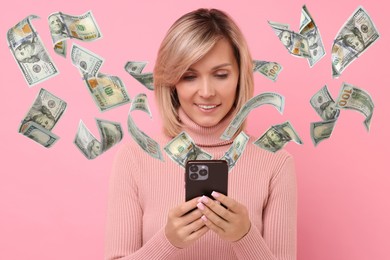 Image of Happy woman using mobile phone on pink background. Money flying out of device