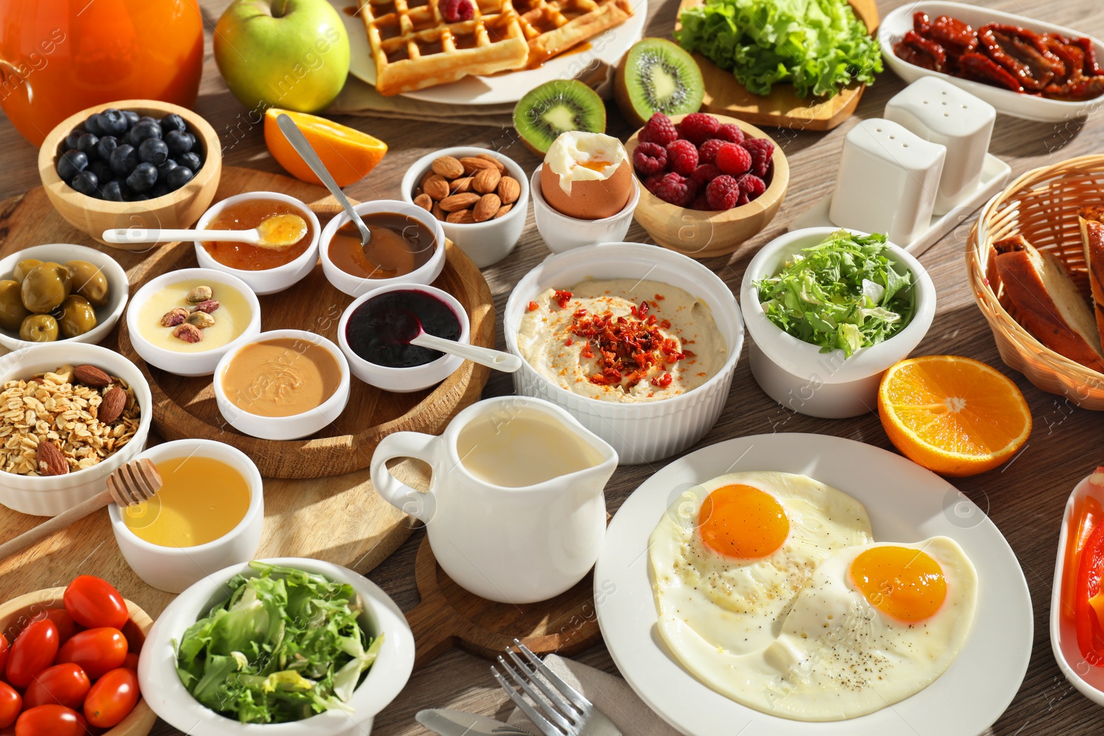 Photo of Different meals served for breakfast on wooden table