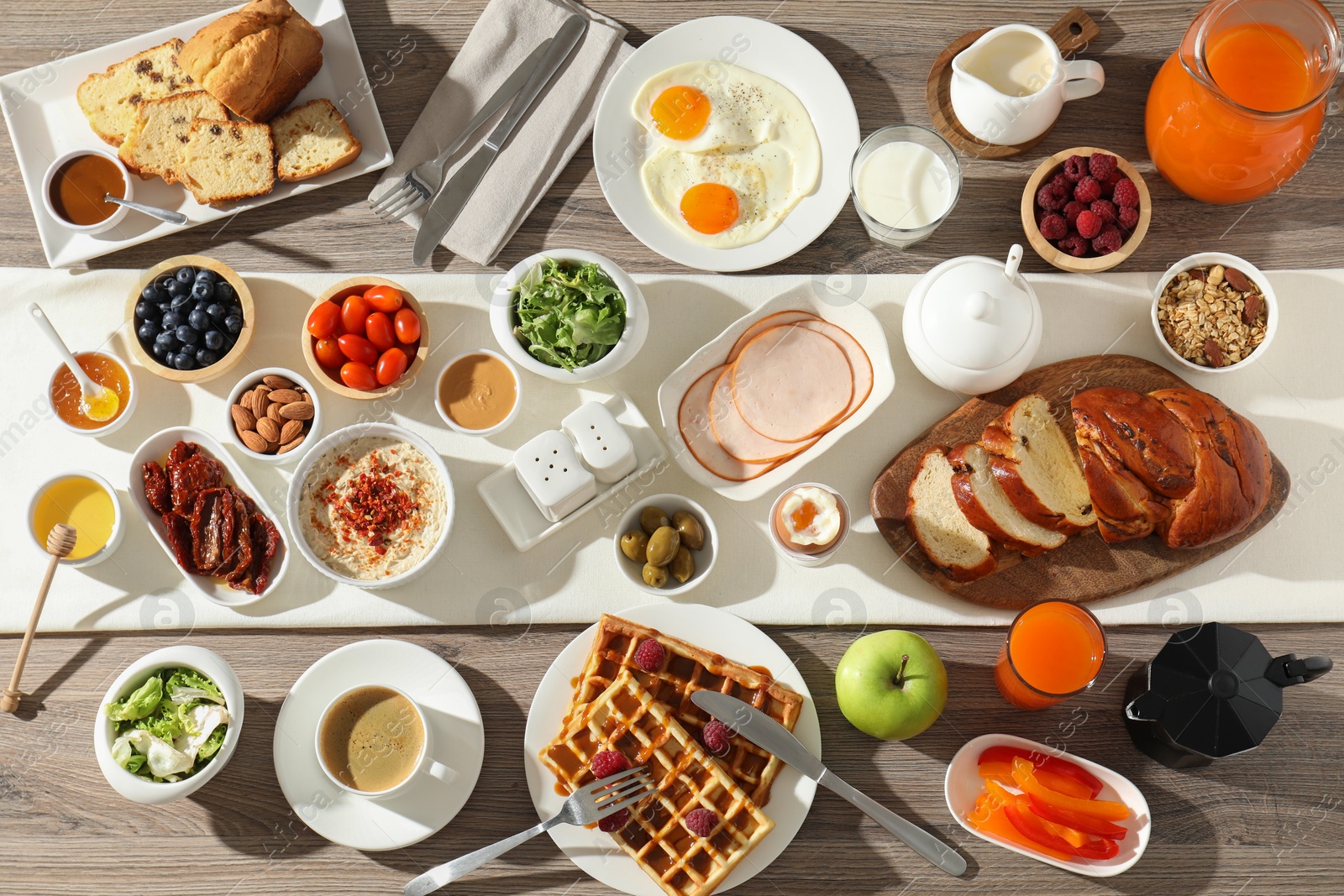 Photo of Different meals served for breakfast on wooden table, flat lay