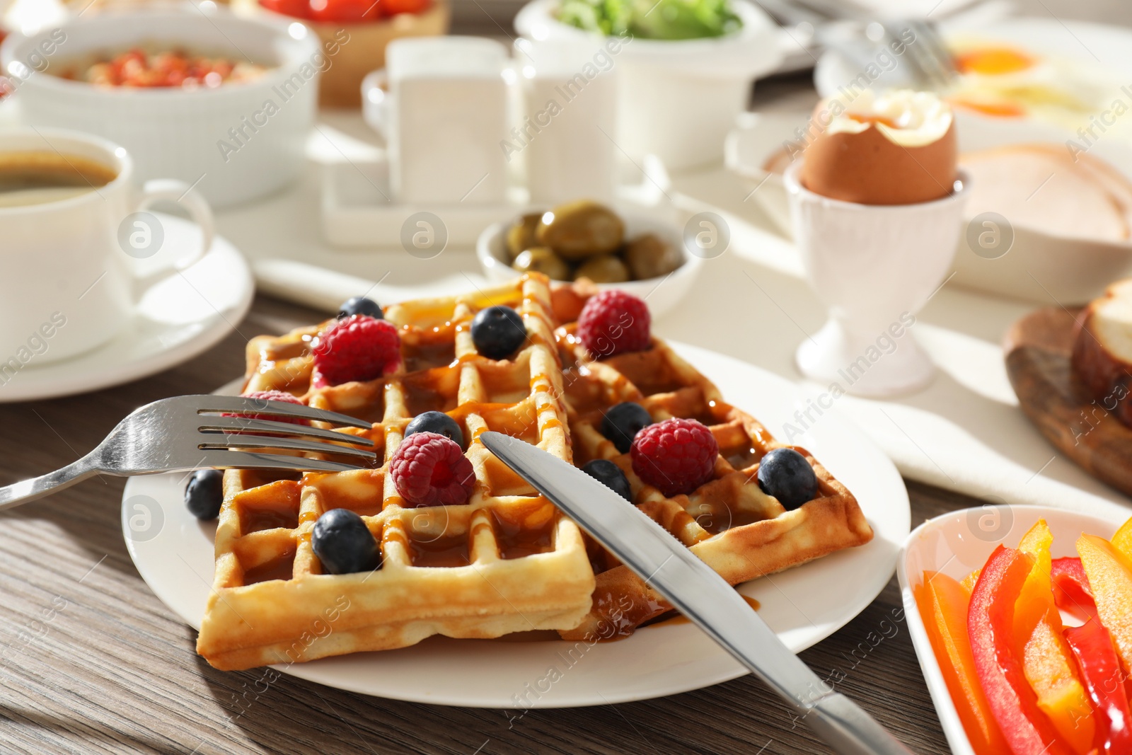 Photo of Different meals served for breakfast on wooden table