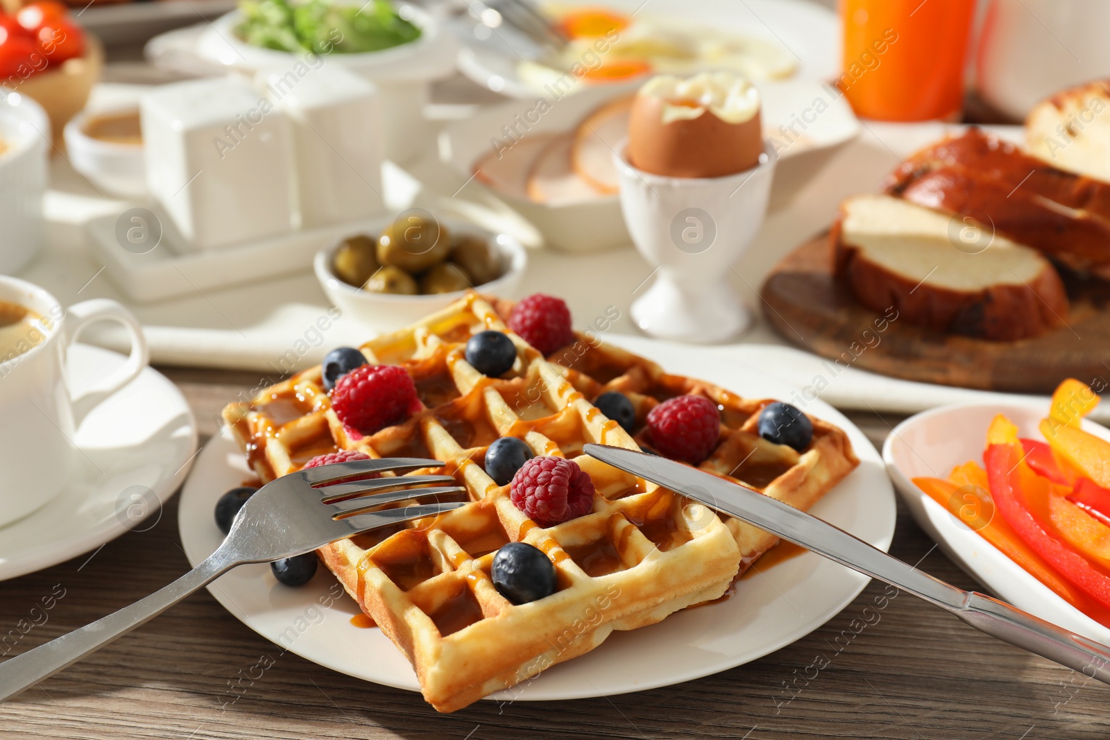 Photo of Different meals served for breakfast on wooden table