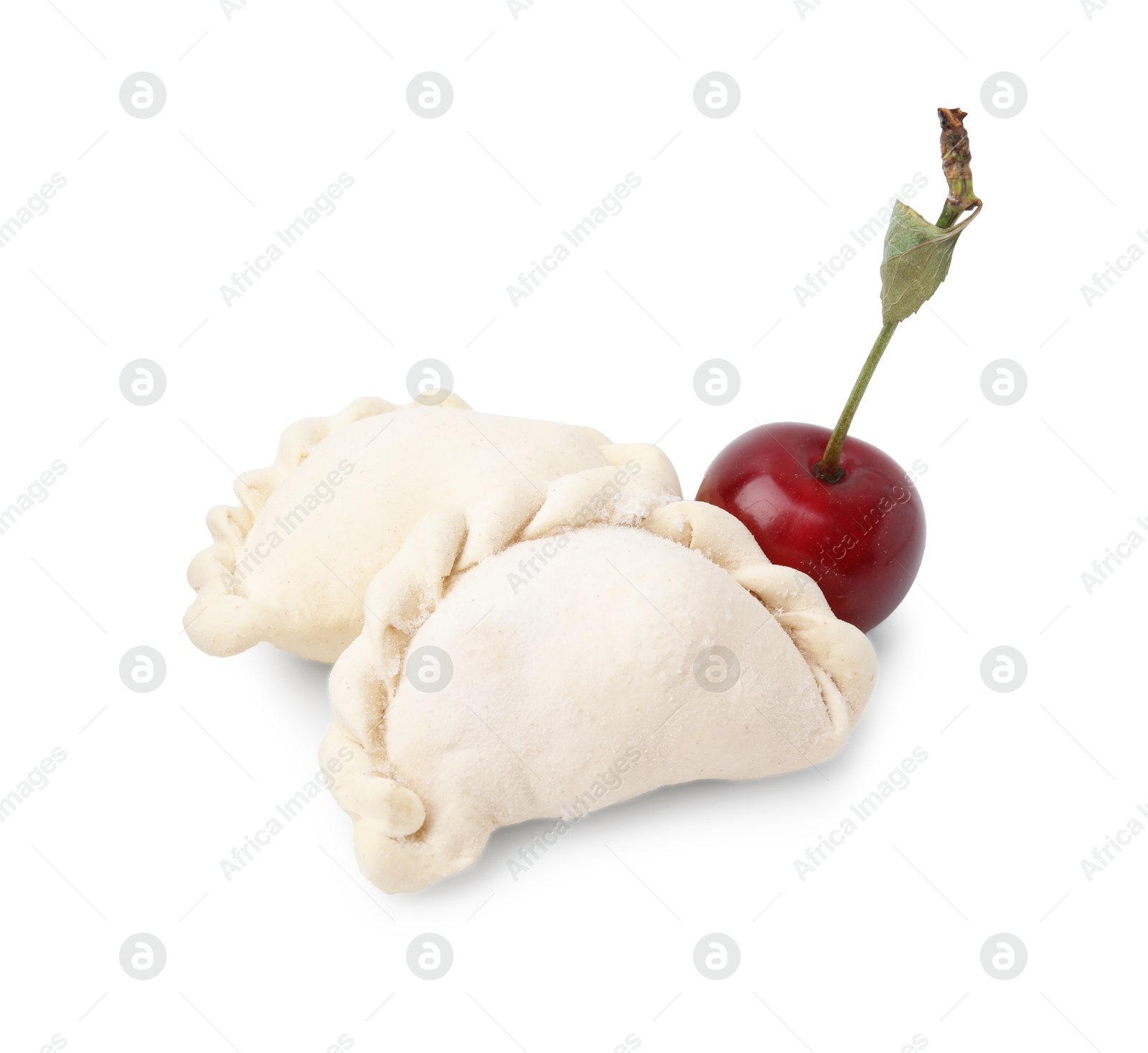 Photo of Frozen dumplings (varenyky) and fresh cherries isolated on white. Ukrainian cuisine