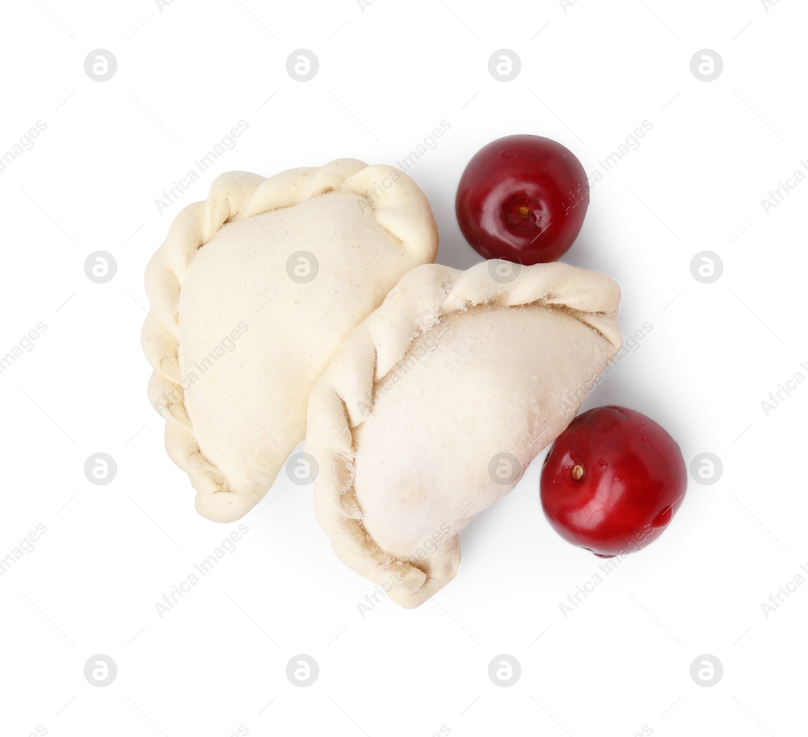 Photo of Frozen dumplings (varenyky) and fresh cherries isolated on white. Ukrainian cuisine