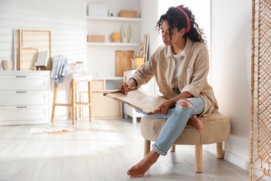 Photo of Beautiful woman drawing picture with pencil in studio