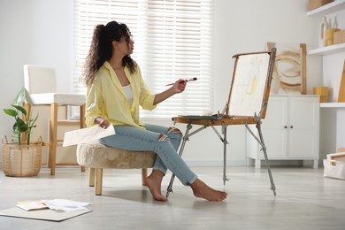 Beautiful woman drawing picture in art studio