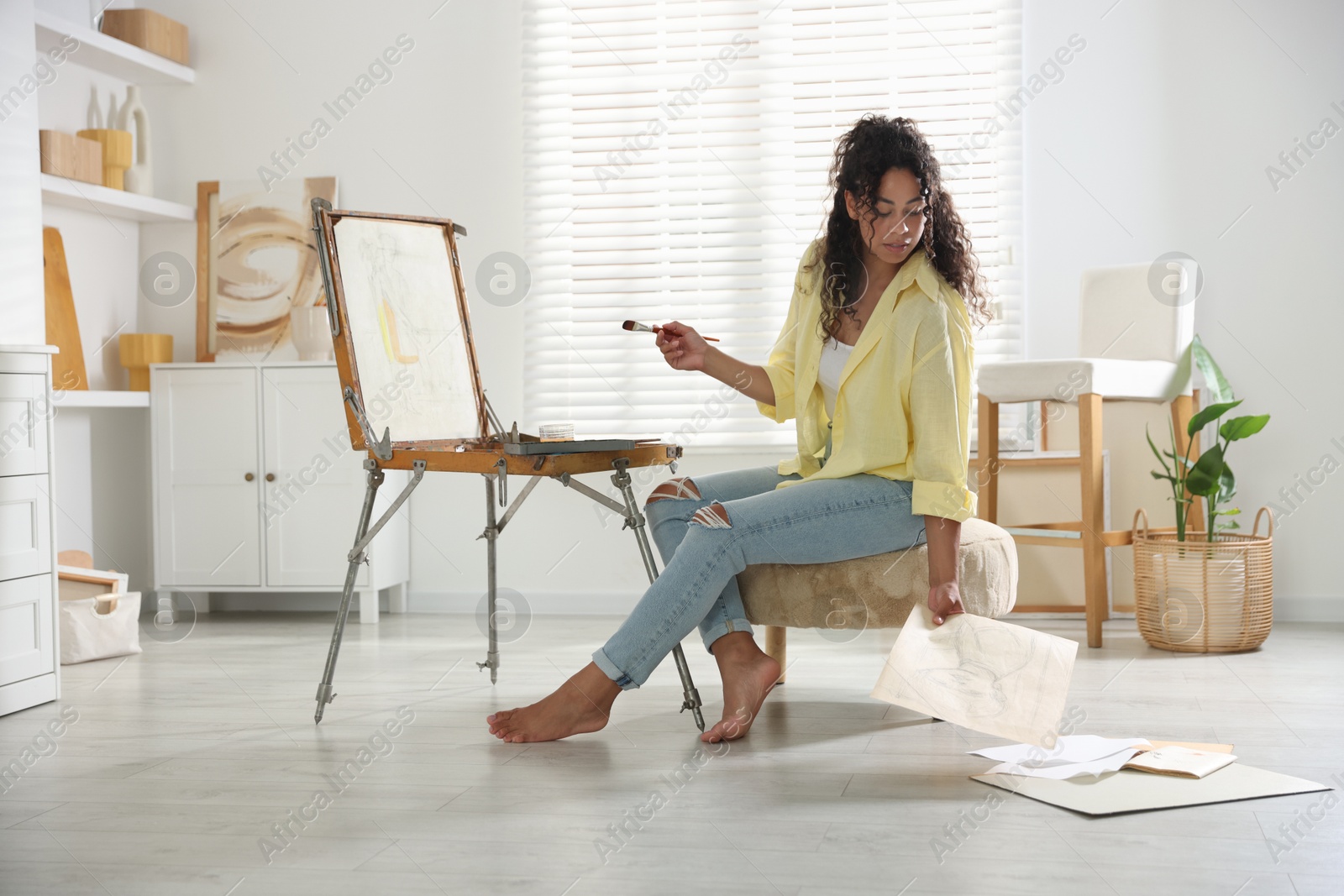 Photo of Beautiful woman drawing picture in art studio