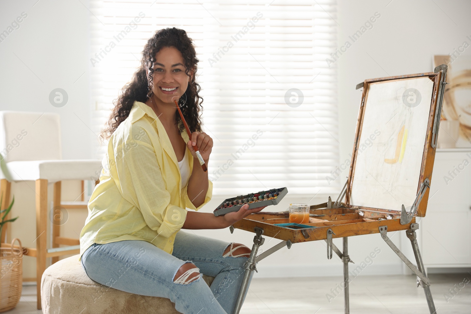 Photo of Smiling woman drawing picture in art studio