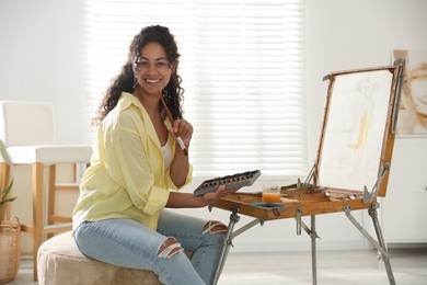 Smiling woman drawing picture in art studio