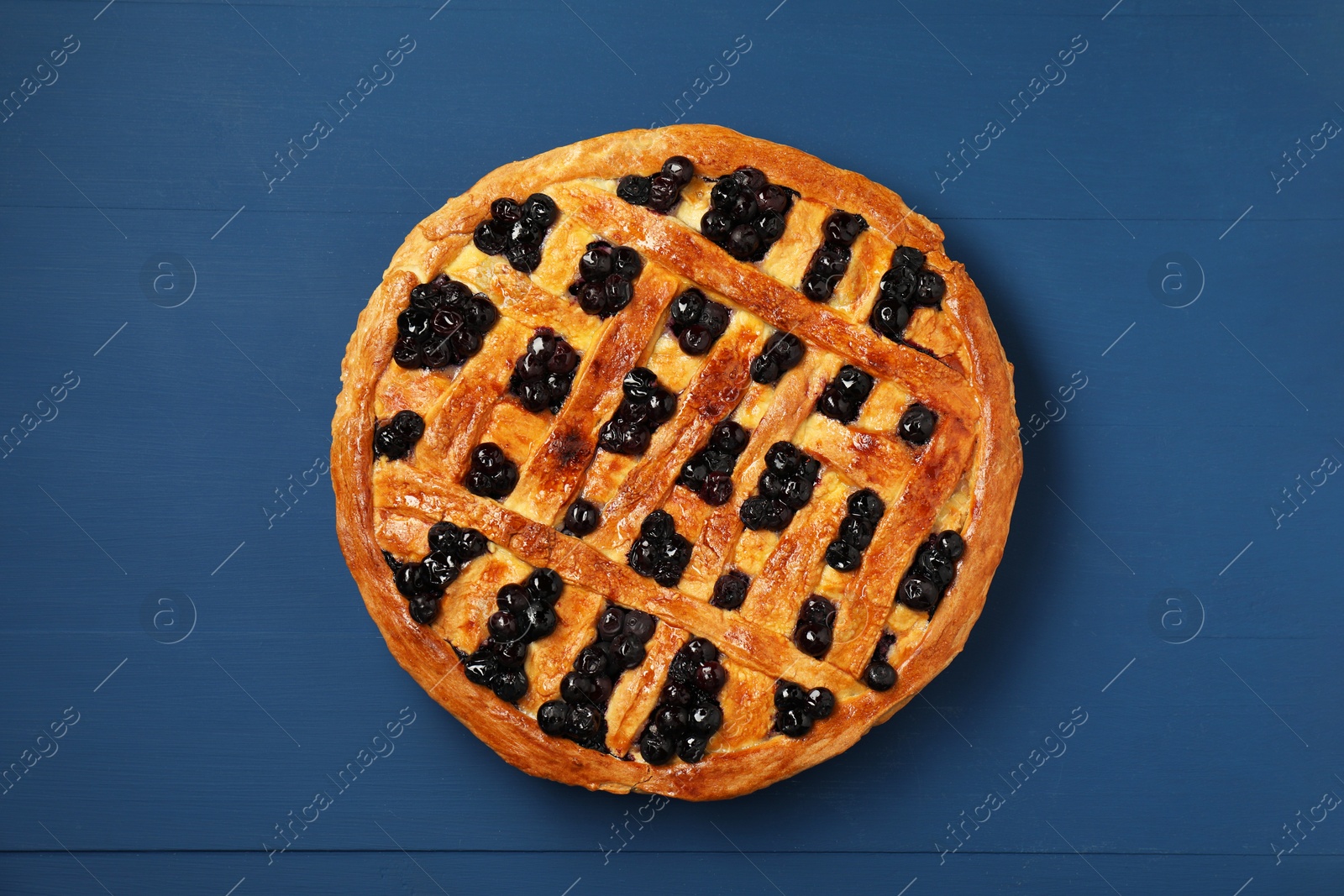 Photo of Tasty homemade pie with blueberries on blue wooden table, top view