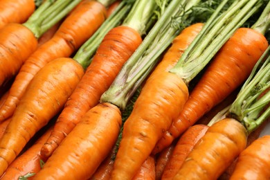 Photo of Tasty ripe juicy carrots as background, closeup