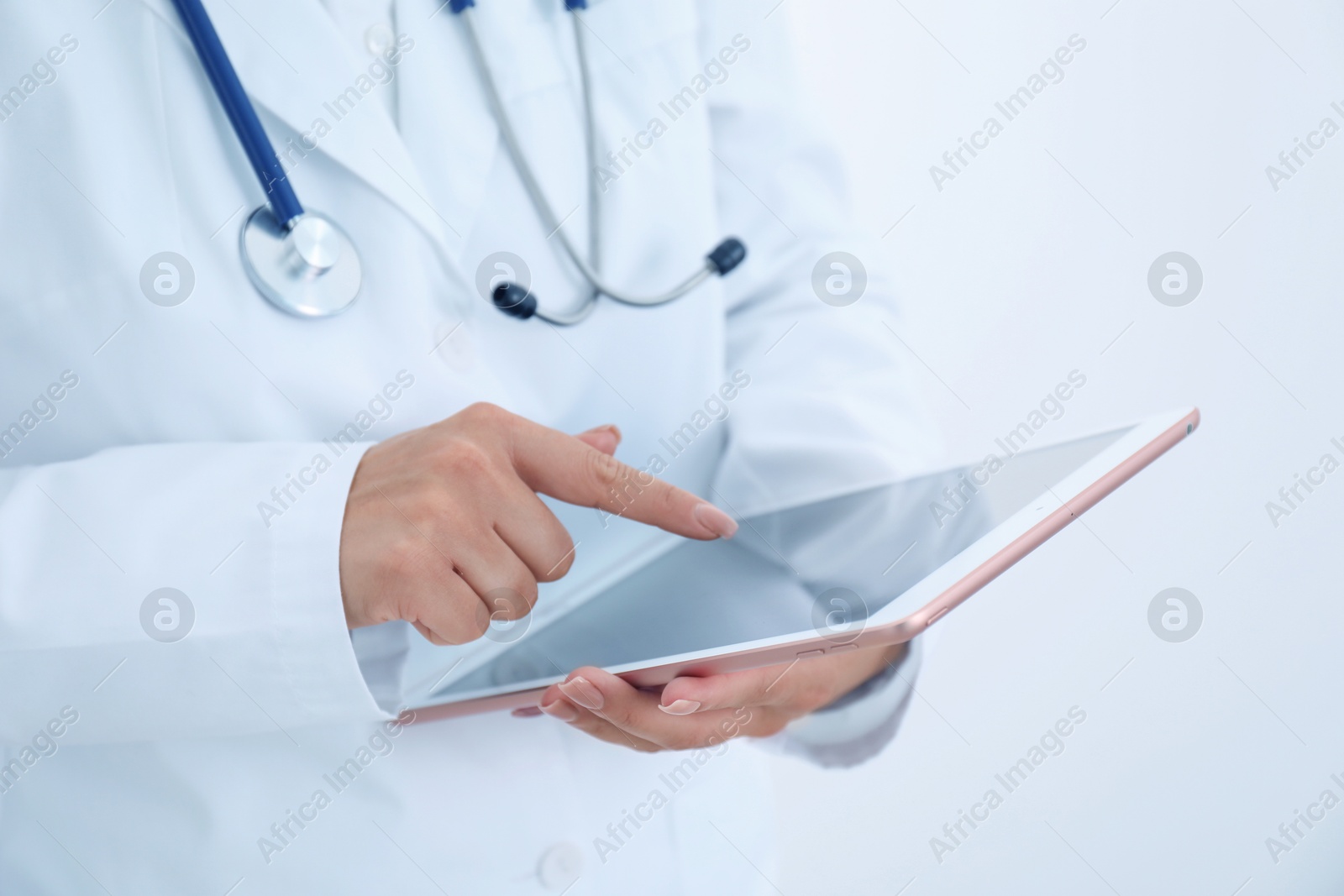 Photo of Doctor with tablet on white background, closeup view