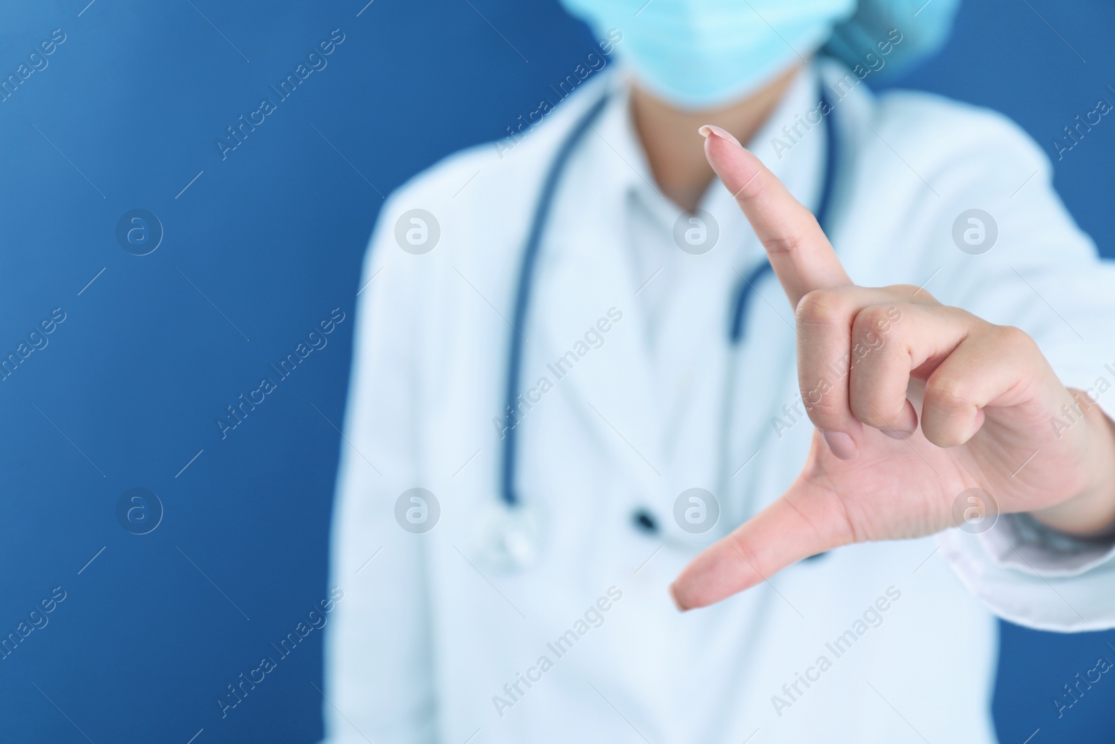 Photo of Doctor holding something on blue background, closeup. Space for text