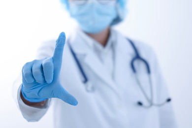 Photo of Doctor holding something on white background, closeup