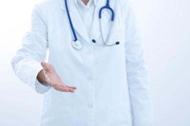 Doctor holding something on white background, closeup