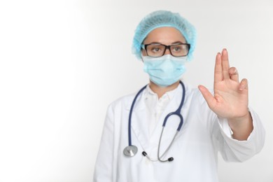 Photo of Doctor touching something on white background, selective focus. Space for text