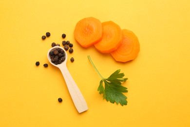 Photo of Slices of fresh ripe carrot, spices and spoon on yellow background, flat lay