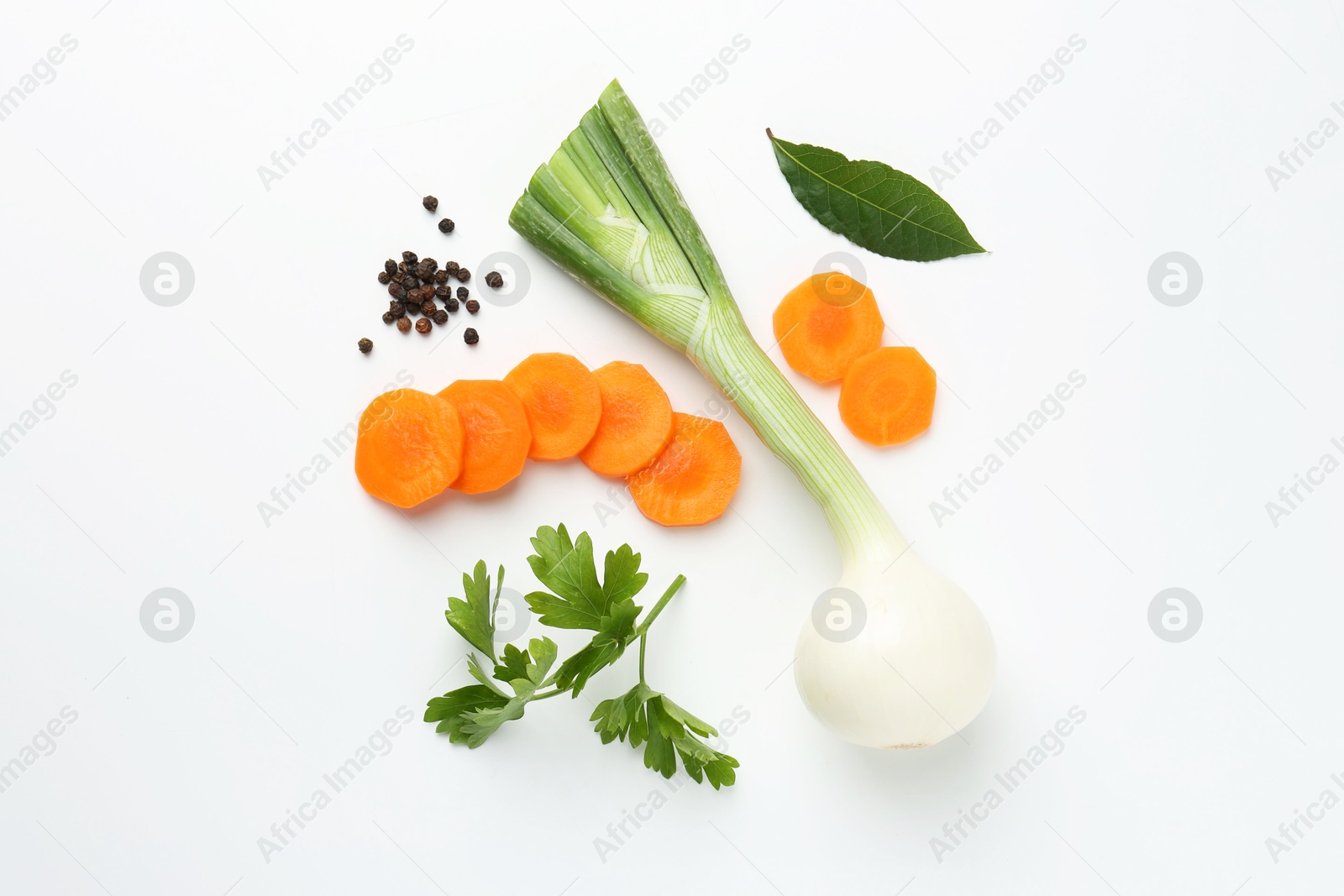 Photo of Pieces of fresh ripe carrot, onion and spices on white background, flat lay