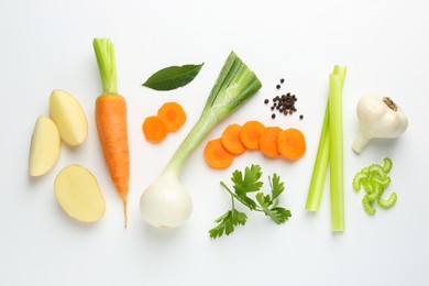 Photo of Pieces of fresh ripe carrots, vegetables and spices on white background, flat lay