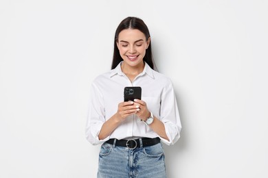 Photo of Smiling woman with smartphone on white background