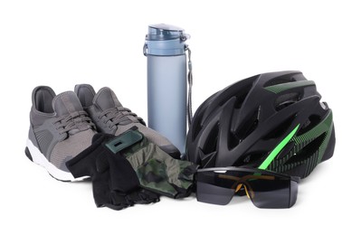 Photo of Bicycle helmet, sneakers, thermo bottle, goggles and fingerless gloves isolated on white