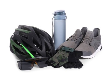 Bicycle helmet, sneakers, thermo bottle, goggles and fingerless gloves isolated on white