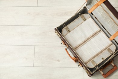 Open empty suitcase on floor indoors, top view. Space for text