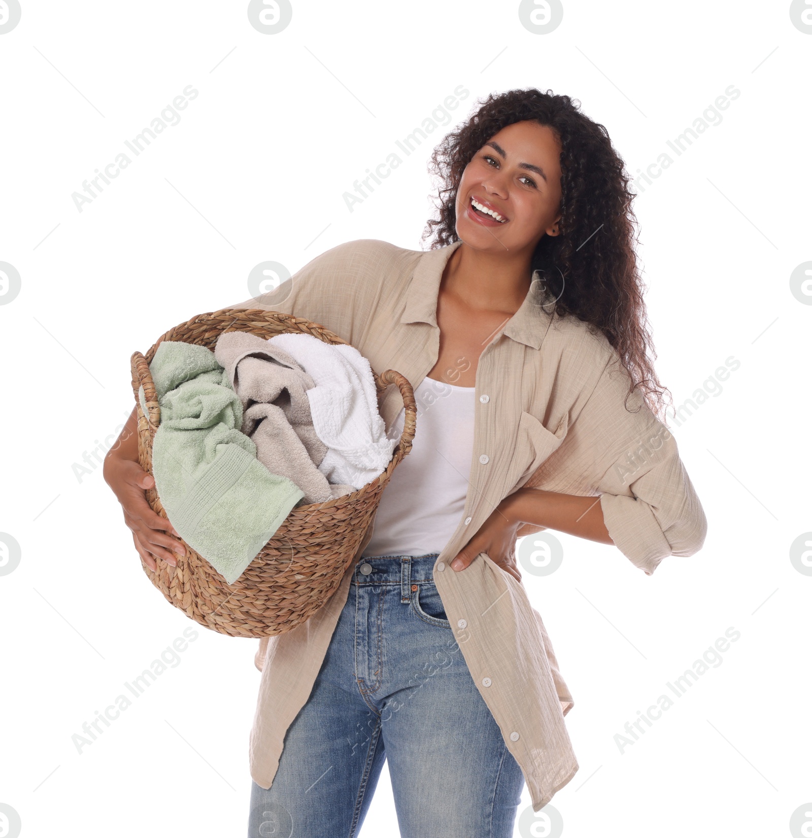 Photo of Happy woman with basket full of laundry on white background