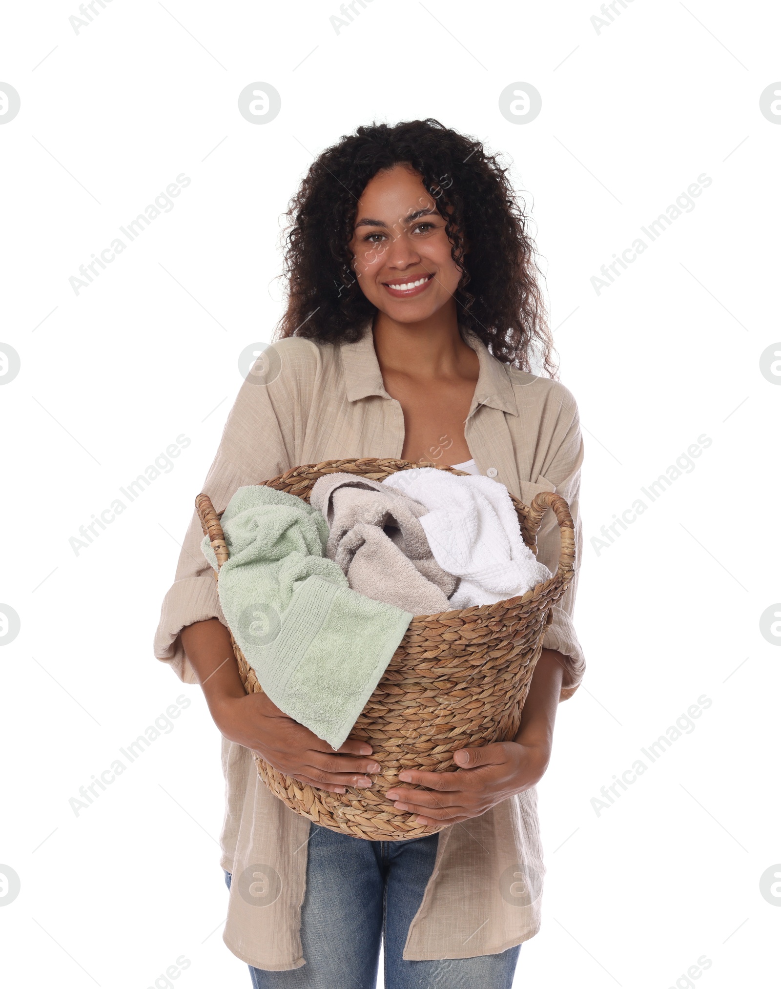 Photo of Happy woman with basket full of laundry on white background