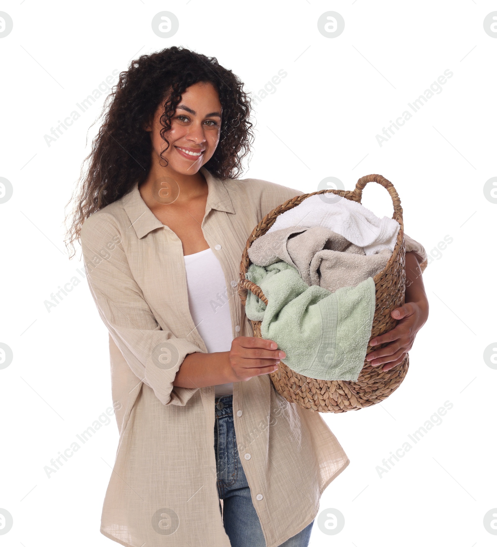 Photo of Happy woman with basket full of laundry on white background