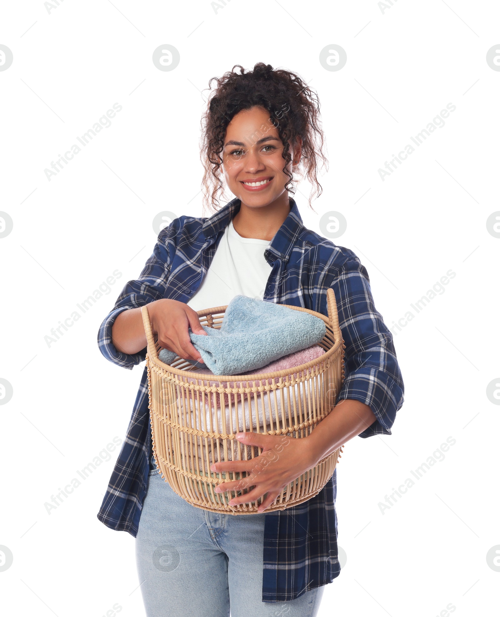 Photo of Happy woman with basket full of laundry on white background