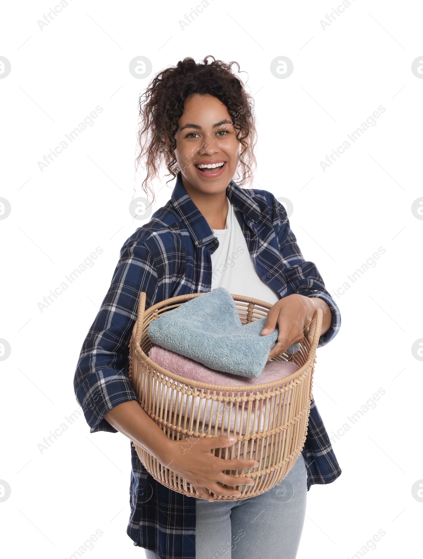 Photo of Happy woman with basket full of laundry on white background