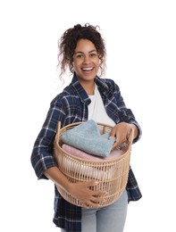 Photo of Happy woman with basket full of laundry on white background