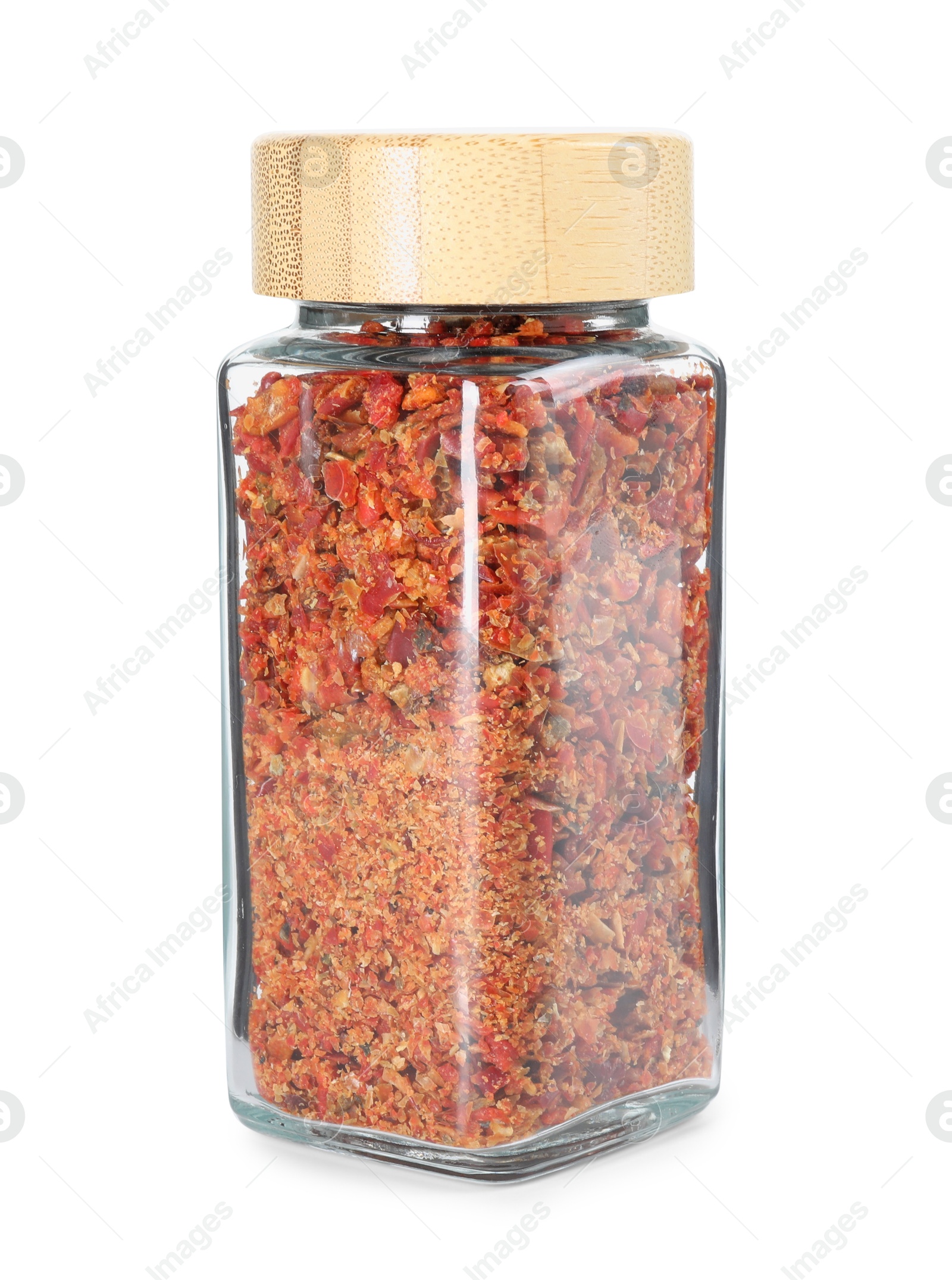 Photo of Red chili pepper flakes in glass jar isolated on white