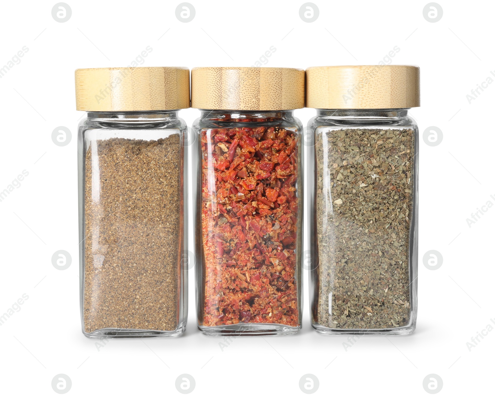 Photo of Different spices in glass jars isolated on white