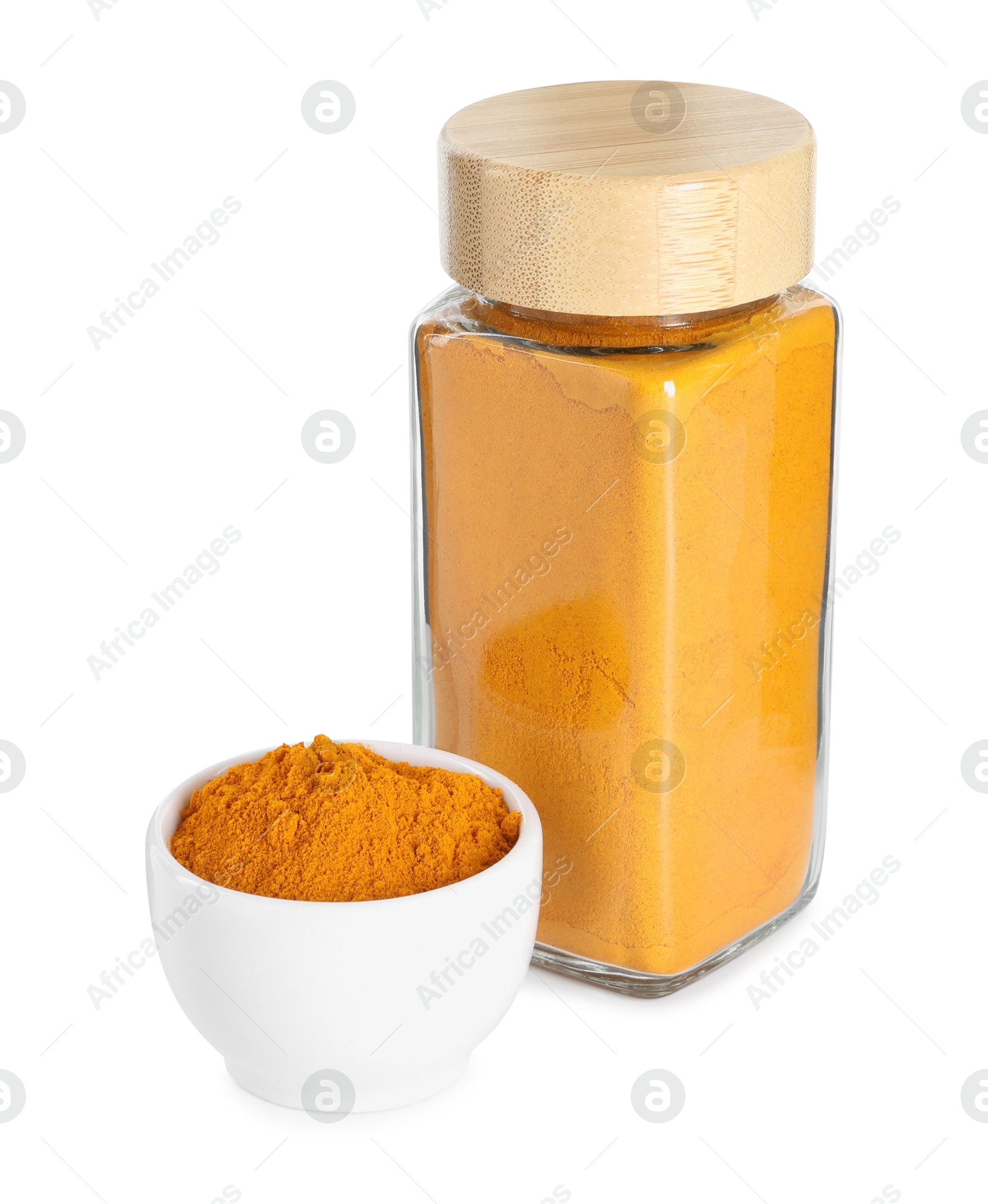 Photo of Curry powder in glass jar and bowl isolated on white