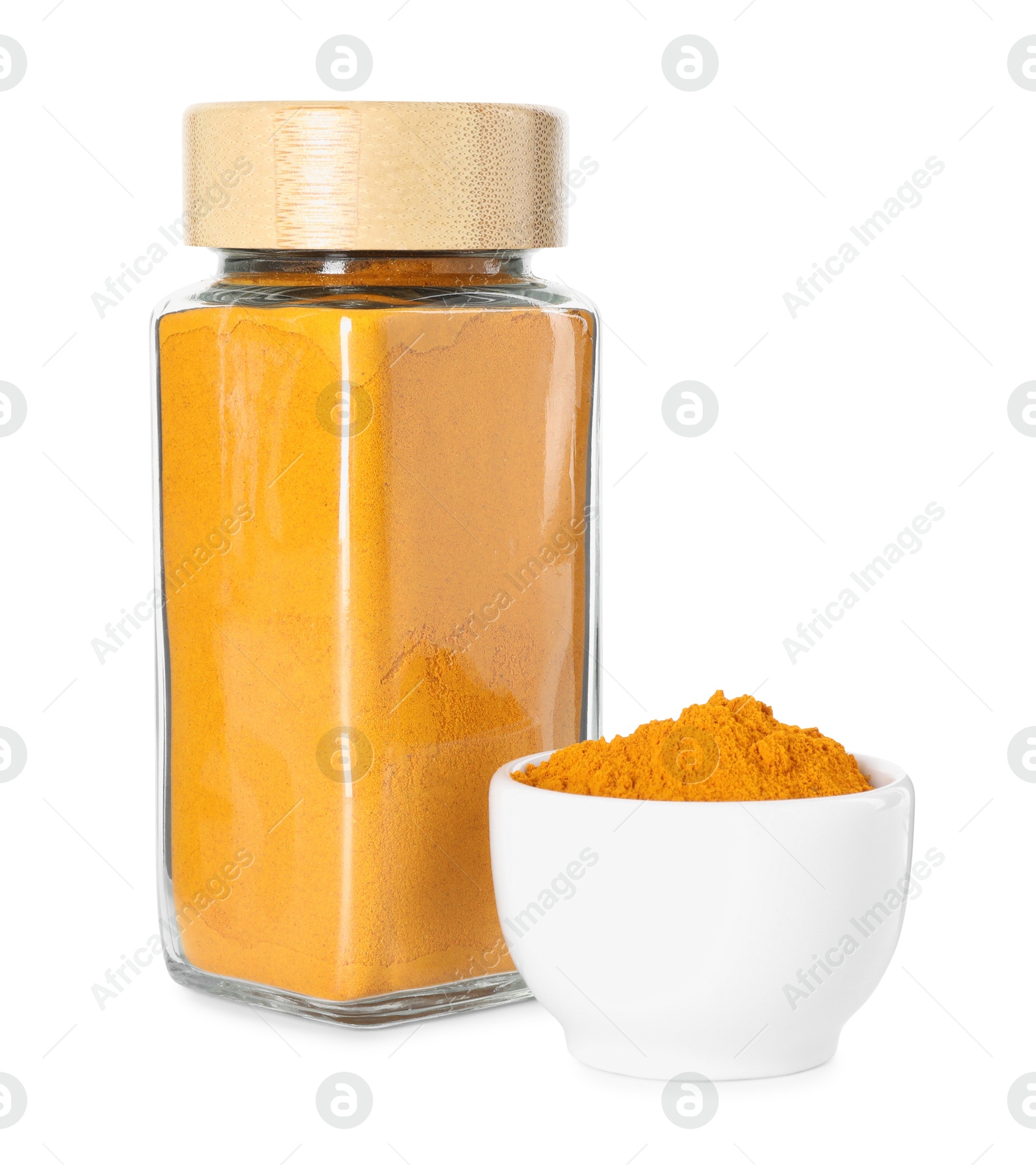 Photo of Curry powder in glass jar and bowl isolated on white