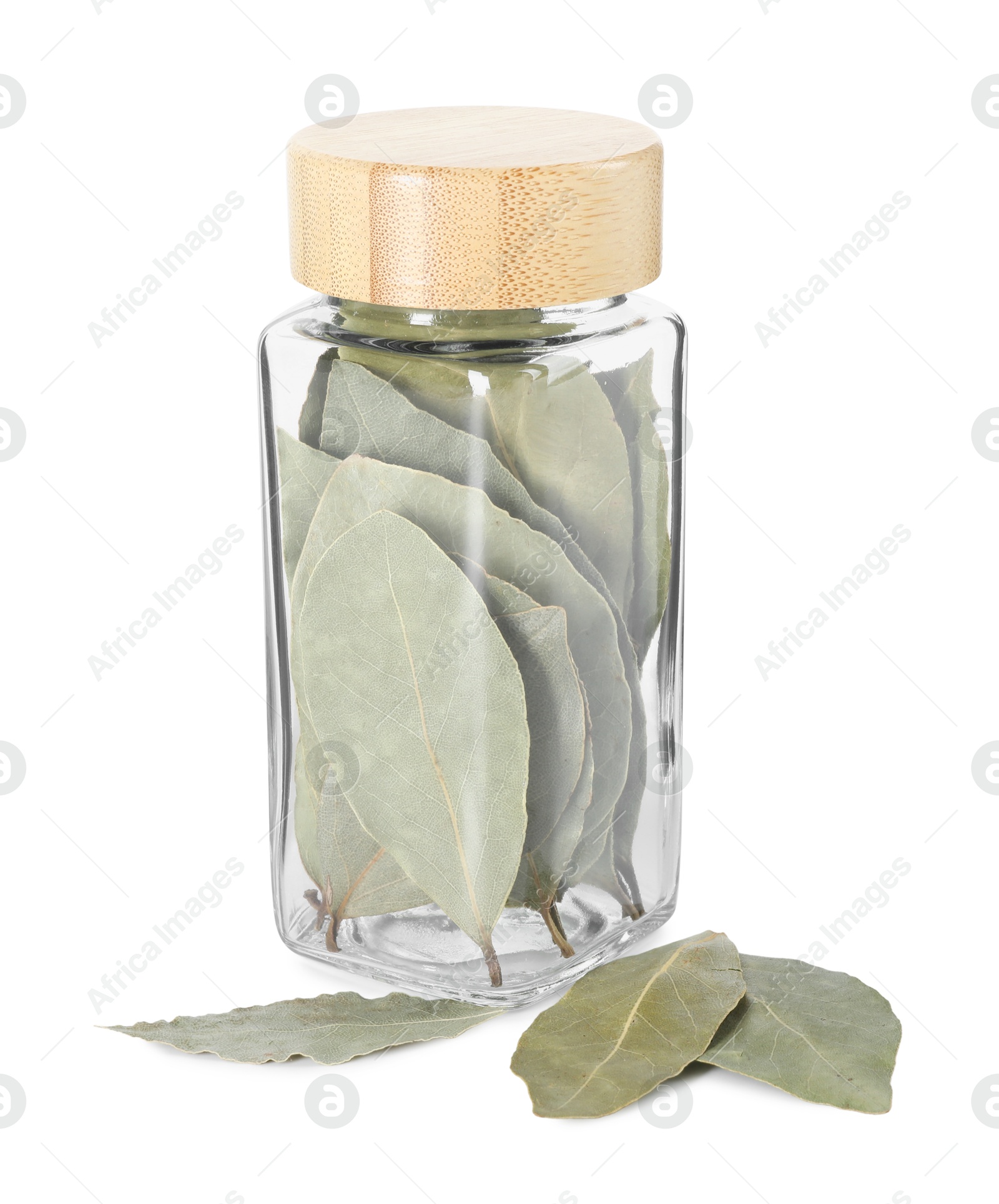 Photo of Dry bay leaves in glass jar isolated on white