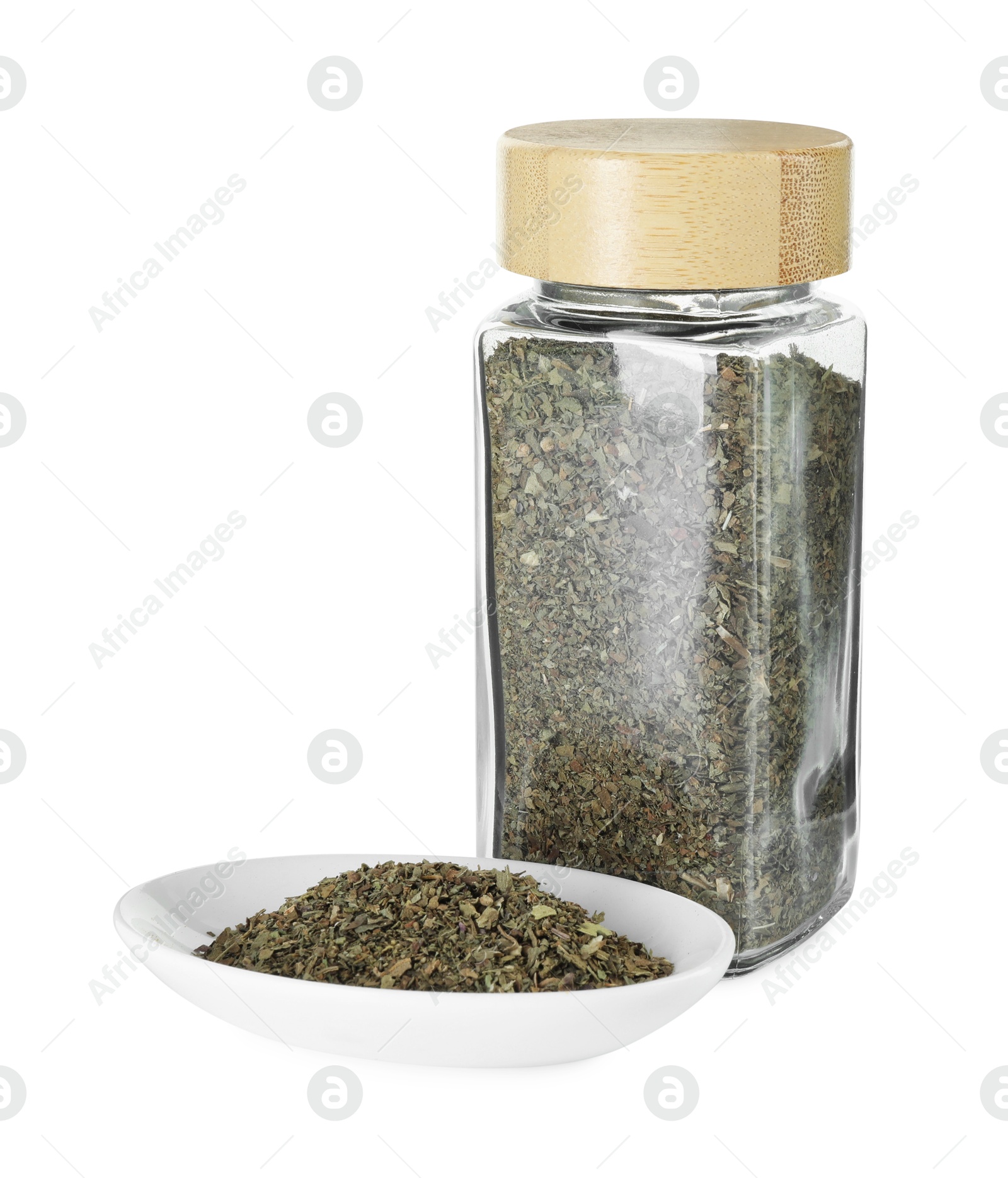 Photo of Dry basil in glass jar isolated on white