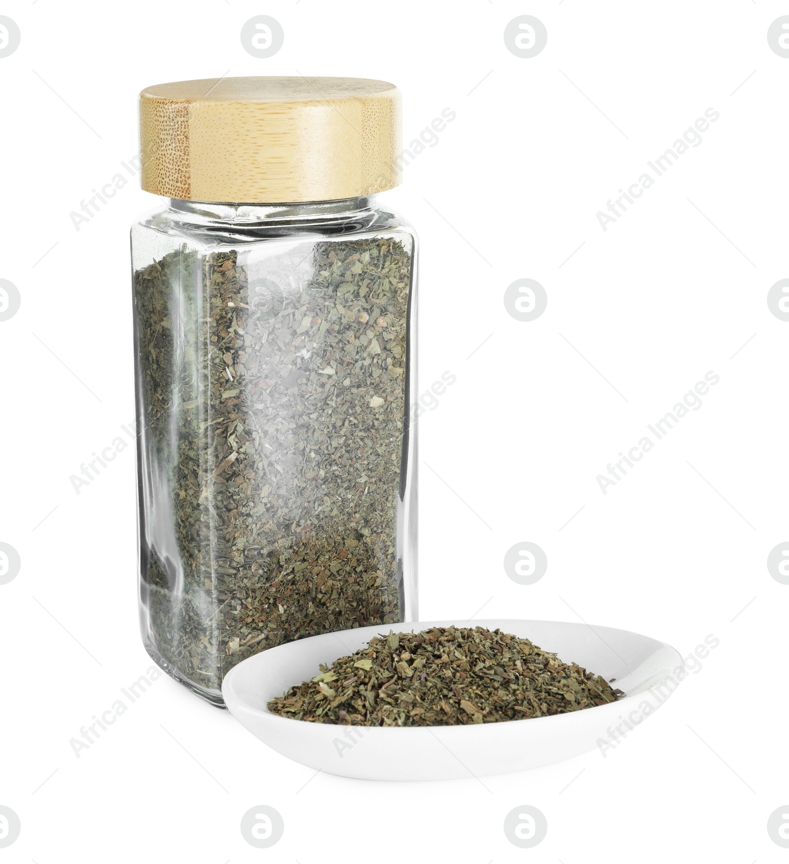 Photo of Dry basil in glass jar isolated on white