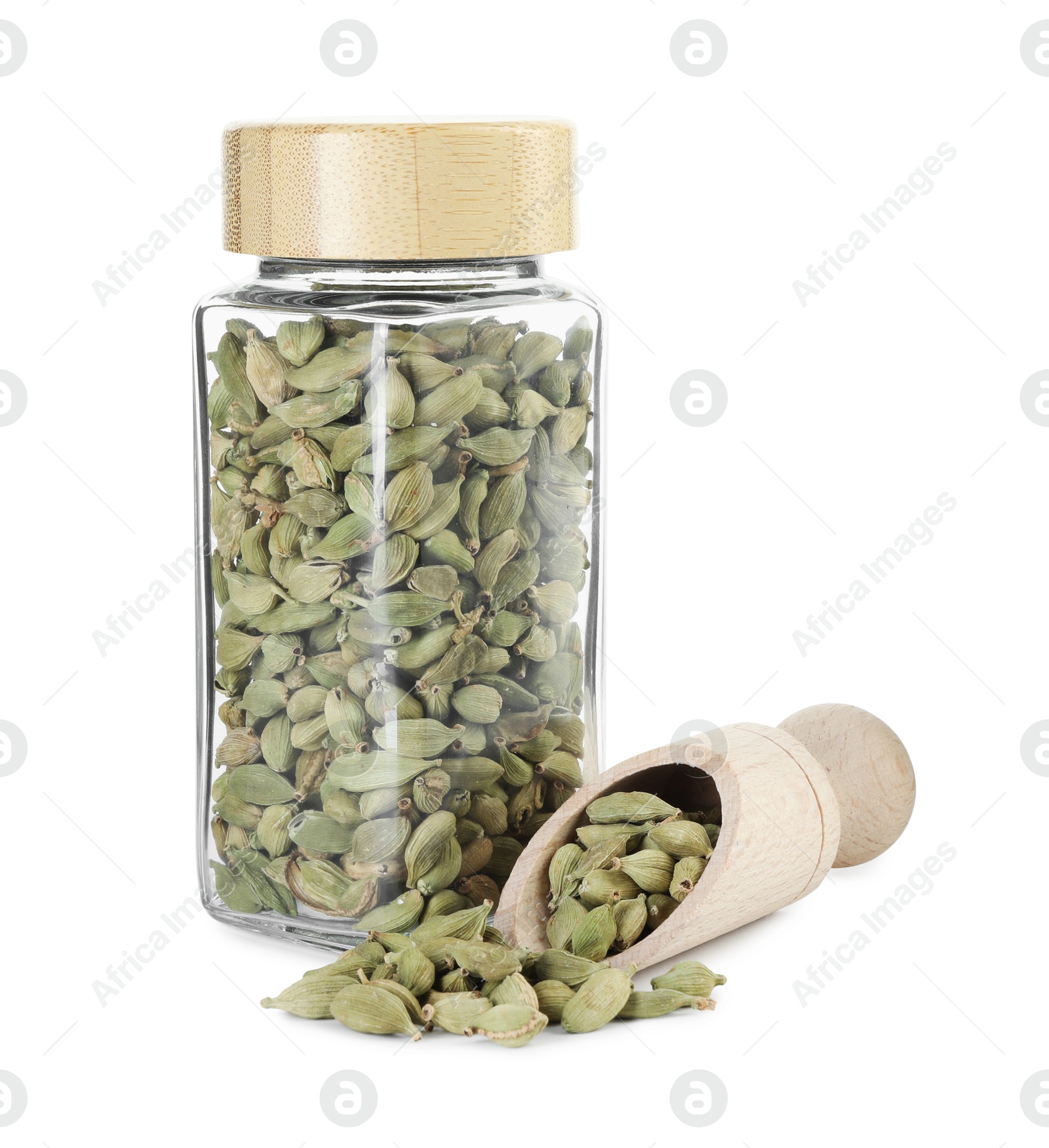 Photo of Cardamom seeds in glass jar and scoop isolated on white