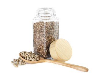 Photo of Coriander in glass jar and spoon isolated on white