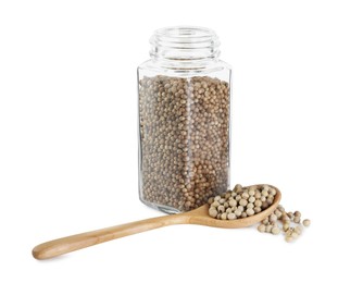 Photo of Coriander in glass jar and spoon isolated on white