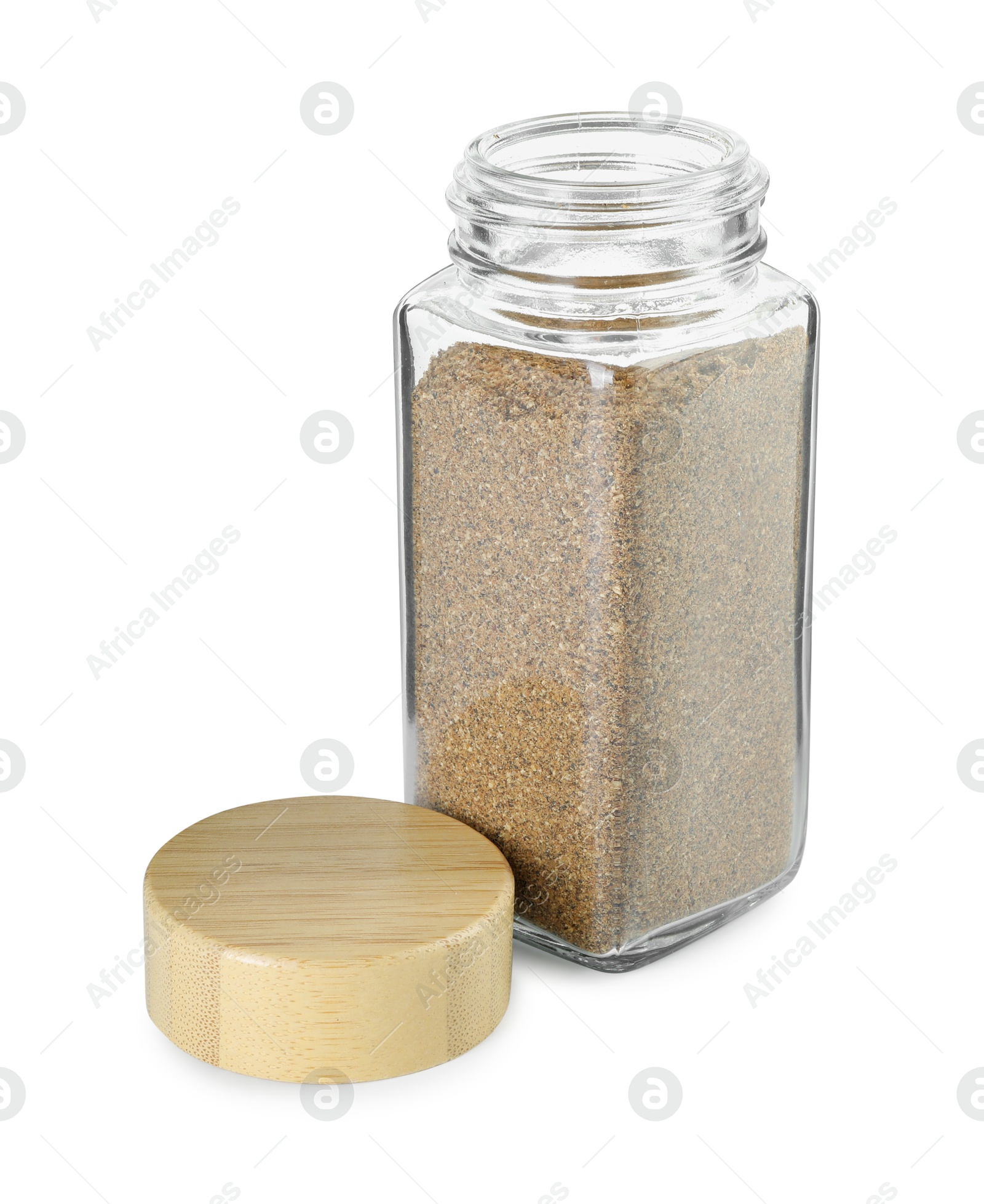 Photo of Cumin powder in glass jar isolated on white