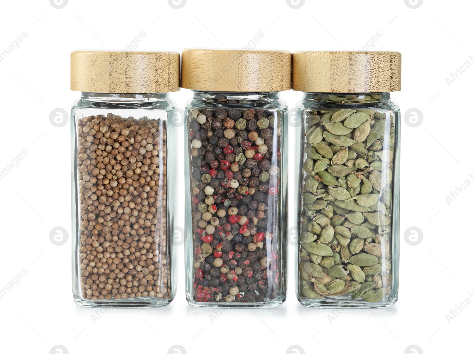 Photo of Different spices in glass jars isolated on white