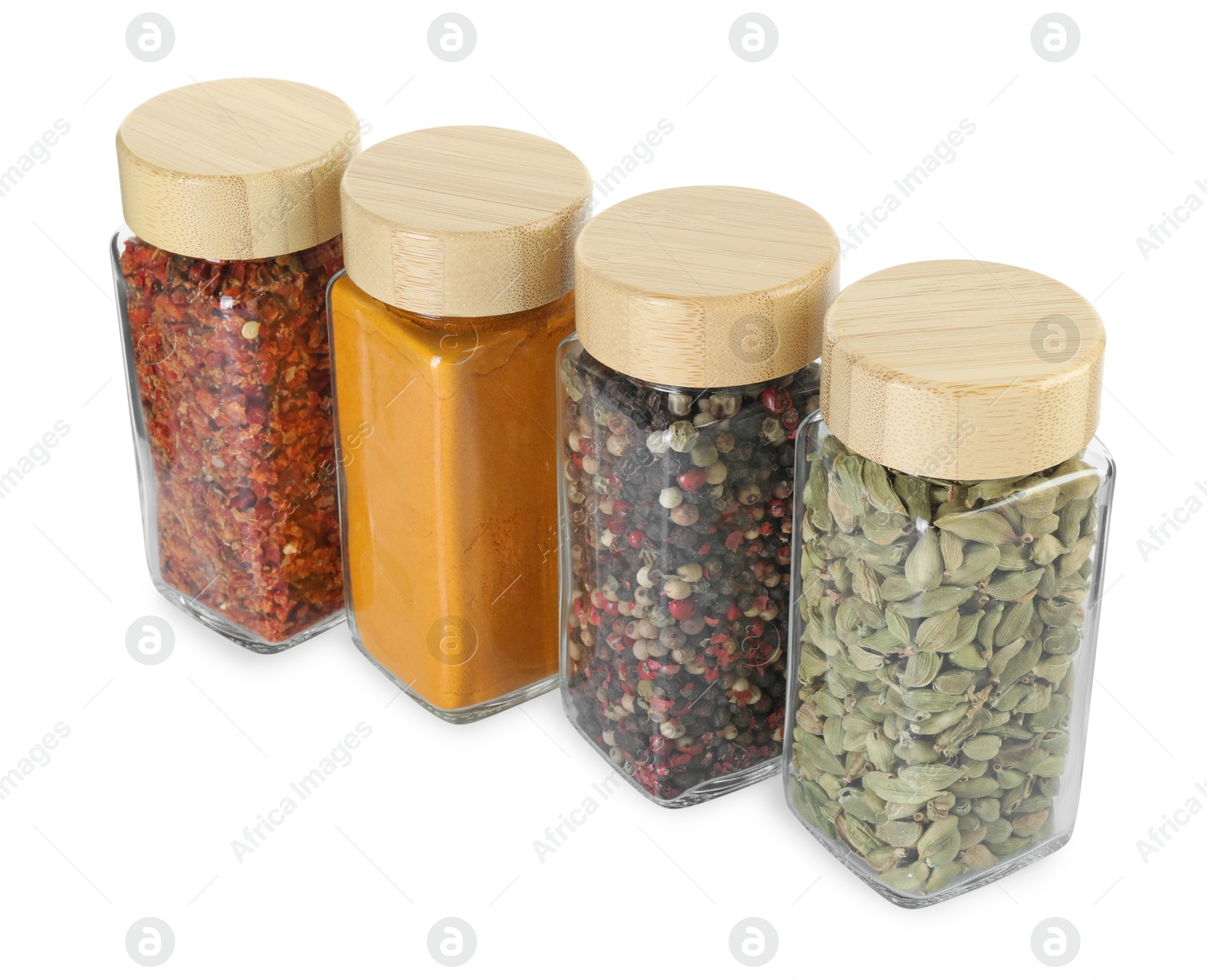 Photo of Different spices in glass jars isolated on white